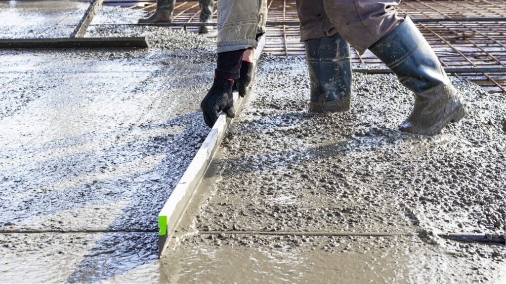 a man screeding concrete