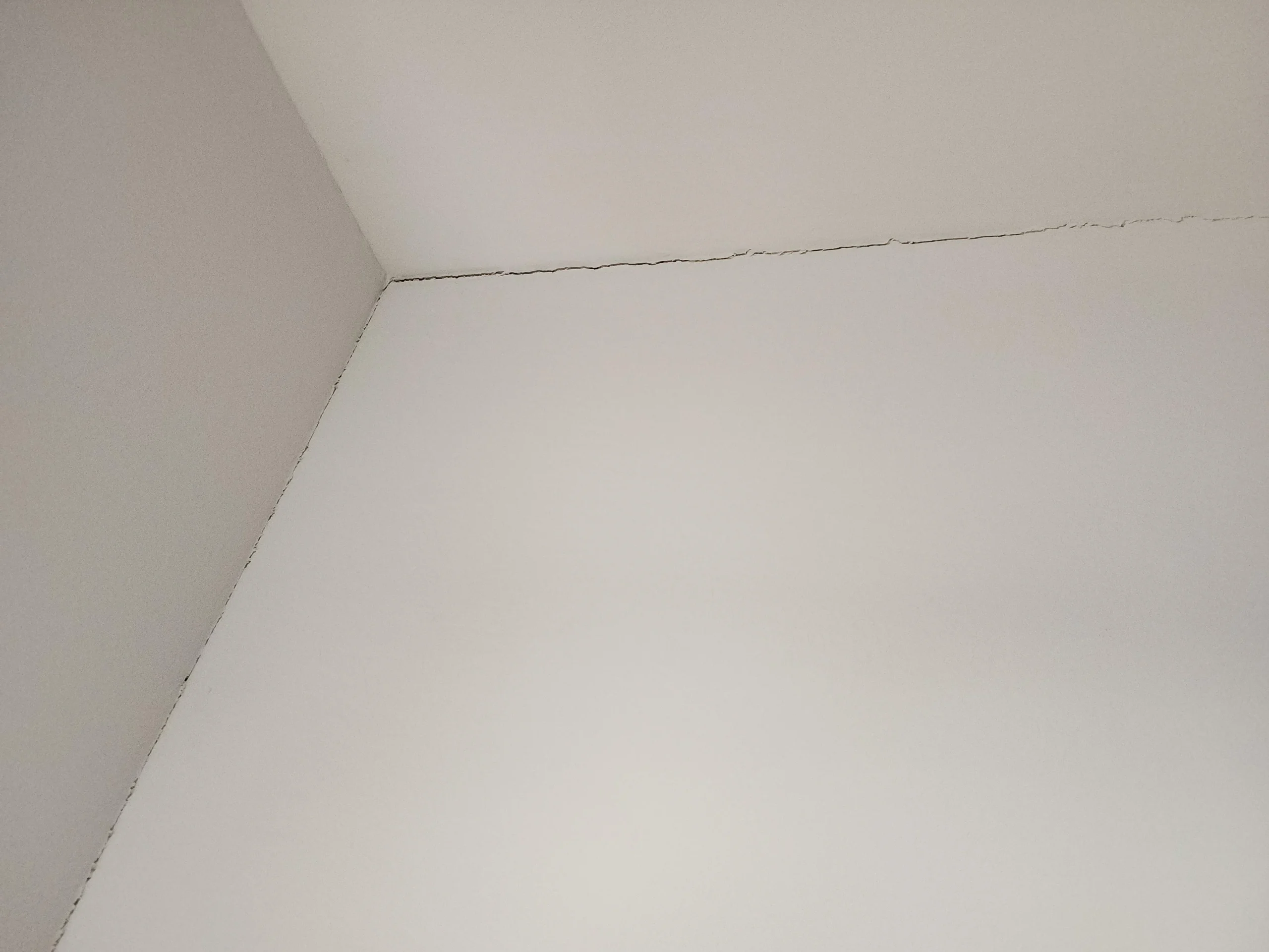 The hairline vertical at the corner of a poured wall