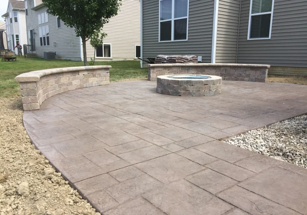 A beautifully stamped concrete patio mimicking natural stone, perfect for creating luxurious outdoor spaces in Calgary communities.
